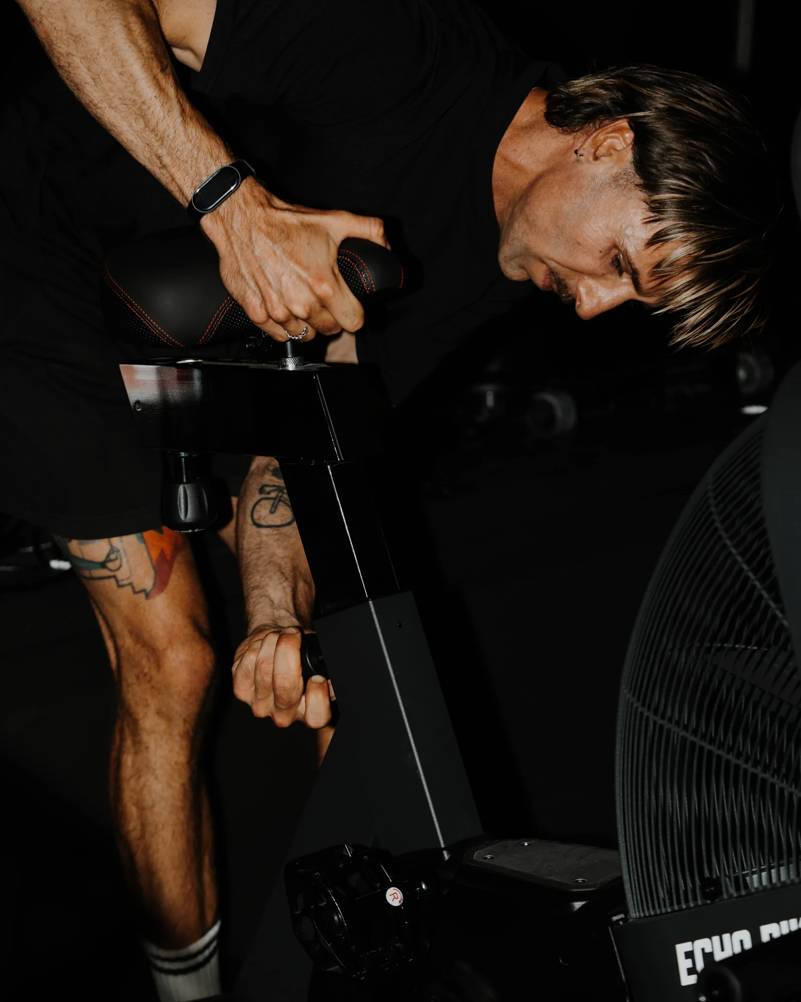 Athlete focused on the Echo Bike during a Hyrox block at ONE PULS