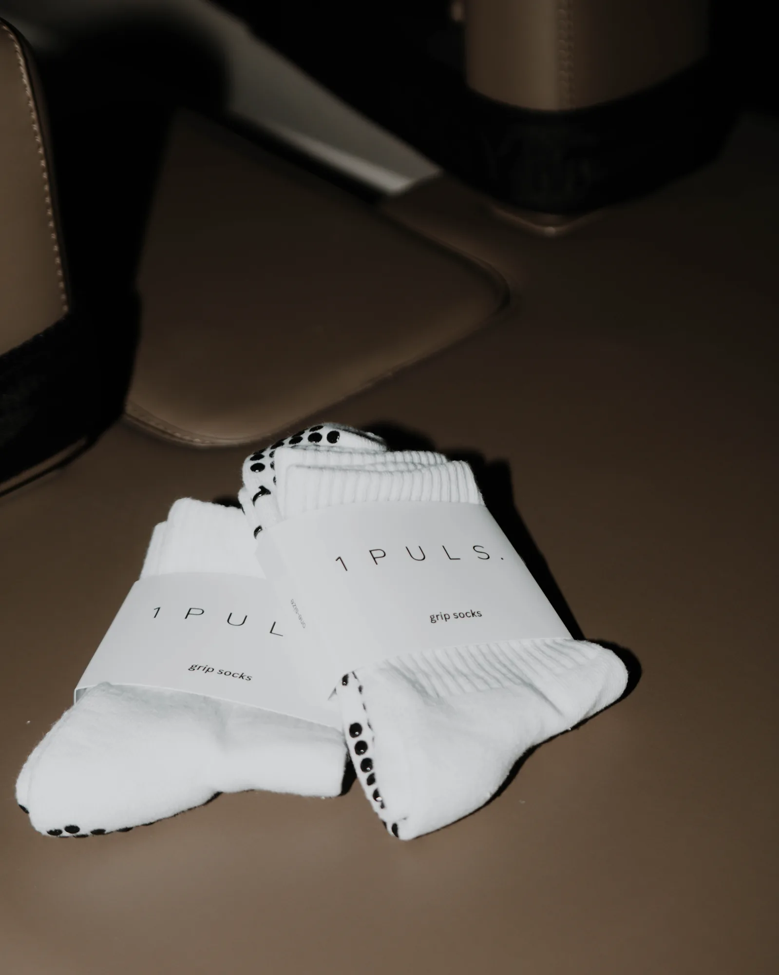 1PULS grip socks folded in the ONE PULS Reformer studio